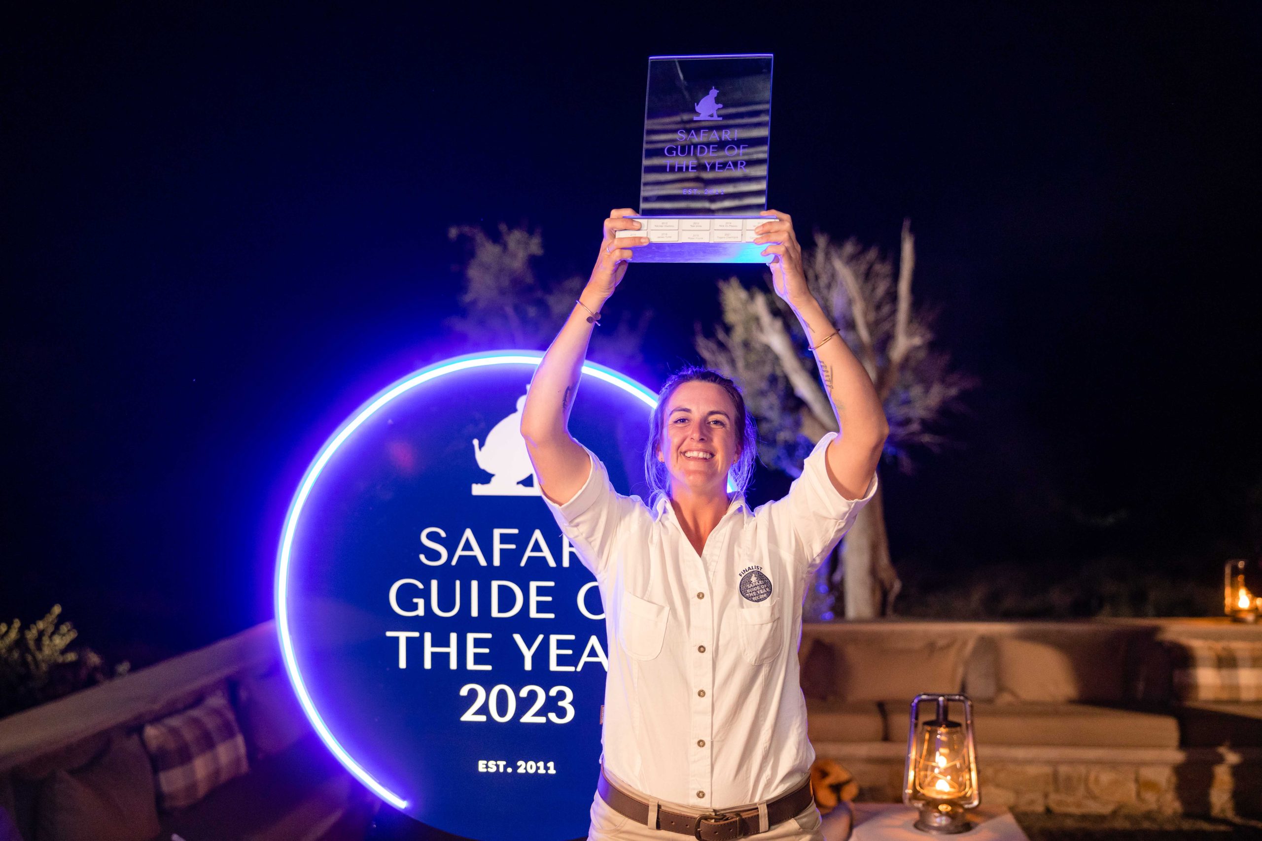 Kimberlee Le Hanie raises the prestigious Safari Guide of the Year trophy in triumph